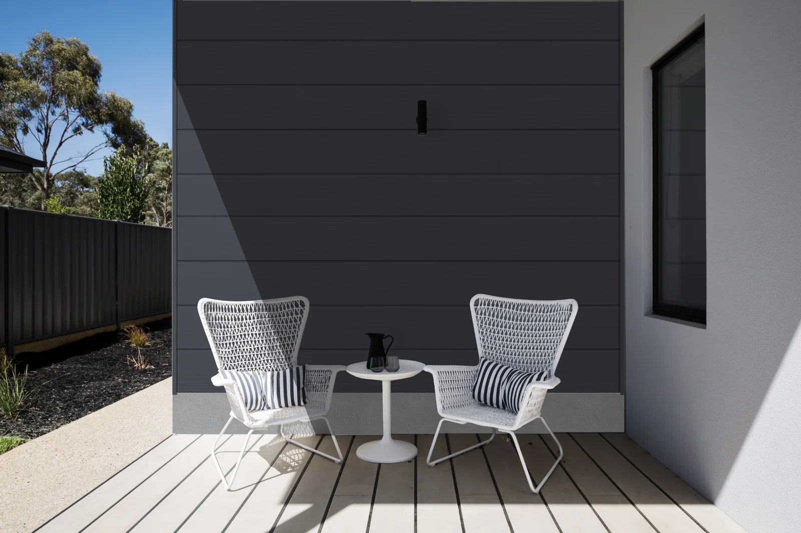 Fortex Clic horizontal slate grey cladding on a landscaped seating area wall